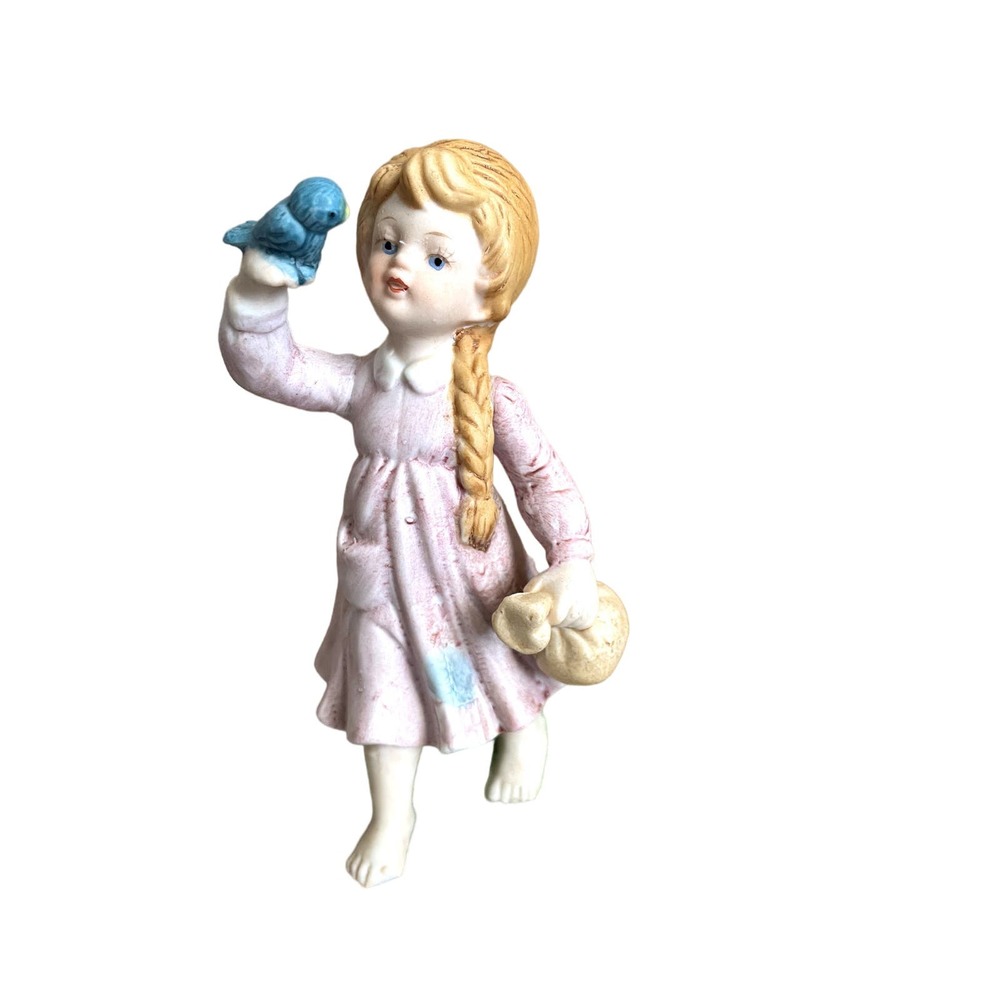 Enesco porcelain little girl sitting on a log holding bluebird 1979